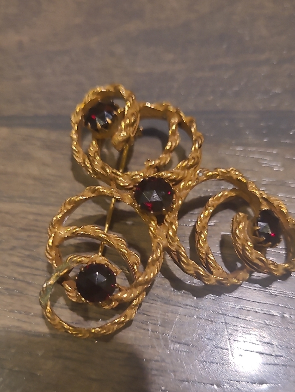 Gold-Tone Twisted Rope Brooch with Deep Red Stones